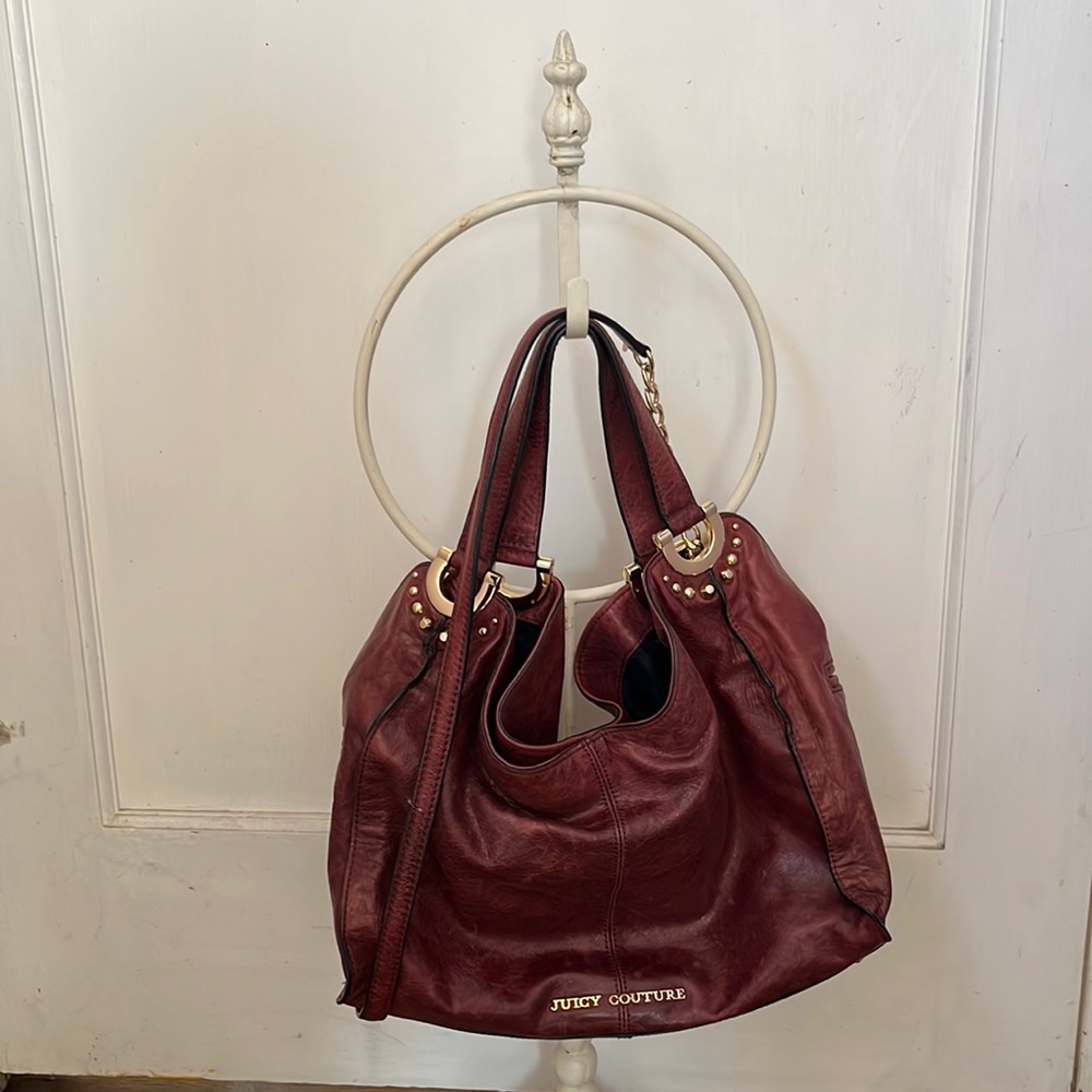 Juicy Couture Genuine Leather burgundy hobo bag with gold chain shoulder strap.